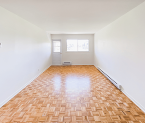 St. John's apartment for rent - A room with a wooden floor and a white door.