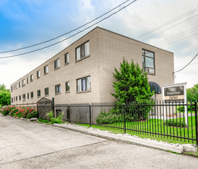 London apartment for rent - A building with the number 1447 on it is surrounded by a black fence.
