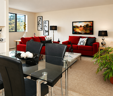 London apartment for rent - A modern living room with a glass dining table and red couch.