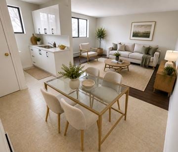 London apartment for rent - A modern living room with a glass table and white chairs.