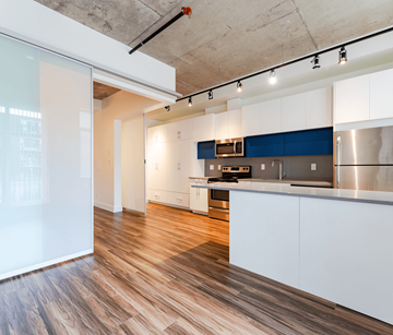 Edmonton apartment for rent - A kitchen with white cabinets and a blue accent wall.