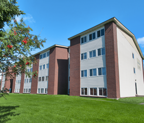 St. John's apartment for rent - A red and white building with a green lawn in front.