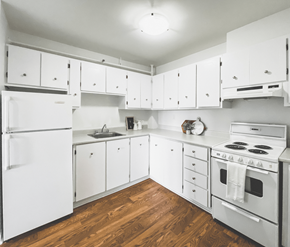 St. John's apartment for rent - A white kitchen with wood floors and white appliances.