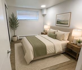 London apartment for rent - A bedroom with a bed, nightstands, and a plant.