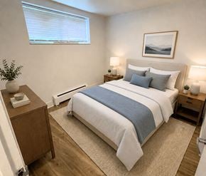 London apartment for rent - A bedroom with a large bed and a painting on the wall.