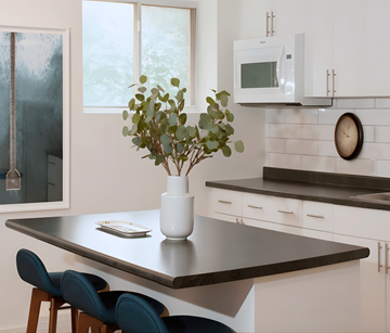 London apartment for rent - A kitchen with a table, chairs, and a vase of flowers.