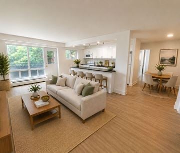 London apartment for rent - A living room with a white couch and a wooden coffee table.