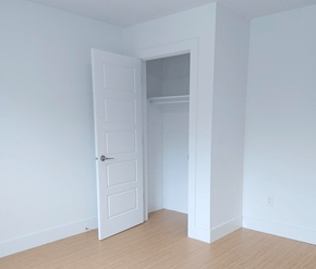 Fredericton apartment for rent - A white door is open to a room with a wooden floor.