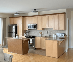 Kanata Ottawa apartment for rent - A modern kitchen with wooden cabinets and stainless steel appliances.