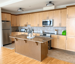 Kanata Ottawa apartment for rent - A kitchen with wooden cabinets and a stainless steel refrigerator.