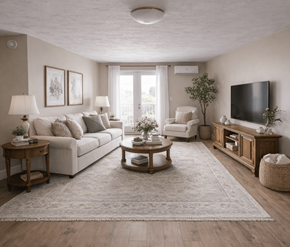Fredericton apartment for rent - A well-lit living room with a large couch, a coffee table, and a flat-screen TV.