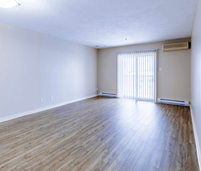 Fredericton apartment for rent - A room with wooden flooring and a window with blinds.