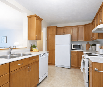 Fredericton apartment for rent - A kitchen with wooden cabinets and white appliances.