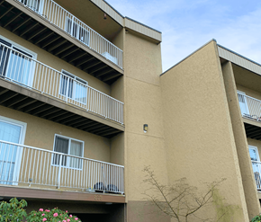 Victoria apartment for rent - A building with beige walls and white railings.
