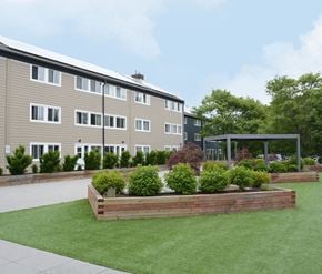 Halifax apartment for rent - A building with a green lawn in front of it.