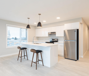 Courtenay apartment for rent - A modern kitchen with a white countertop and a stainless steel refrigerator.