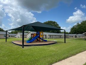 Bay City apartment for rent - a playground with a canopy and slides in a park