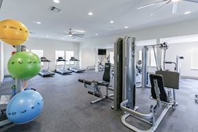 Lake Charles apartment for rent - a large fitness room with treadmills and other exercise equipment