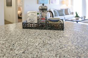 Lake Charles apartment for rent - a coffee pot and a cup on a table with a couch in the background