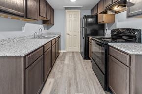Port Arthur apartment for rent - the avenues salt lake custom homes interior kitchen with dark wood cabinets and granite countertops