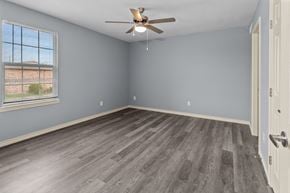Port Arthur apartment for rent - a bedroom with hardwood floors and a ceiling fan