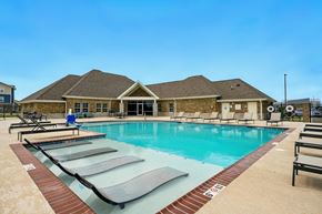 Lake Charles apartment for rent - A large swimming pool with a building in the background.