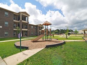 Orange apartment for rent - A playground with a slide and a building in the background.