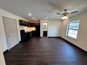 Port Arthur apartment for rent - A spacious room with a kitchen area and a window.