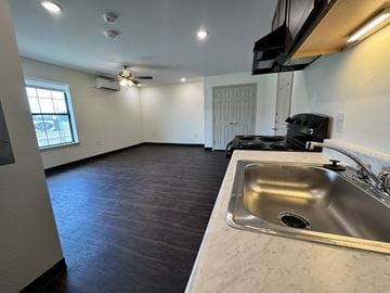 Port Arthur apartment for rent - A kitchen with a sink and a stove top oven.