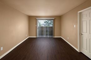Port Arthur apartment for rent - A room with wooden floors and a white door.