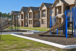 Silsbee apartment for rent - A playground with a slide and a building in the background.