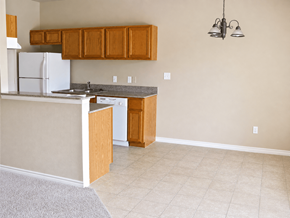 Silsbee apartment for rent - A kitchen with white appliances and wooden cabinets.