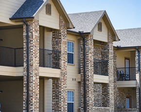 Silsbee apartment for rent - A row of houses with balconies and brick pillars.