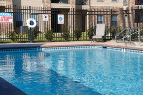 Silsbee apartment for rent - A pool with a warning sign and a life guard on duty.