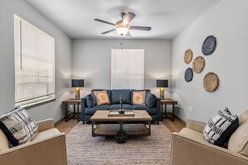 Shreveport apartment for rent - a living room with a couch and a ceiling fan