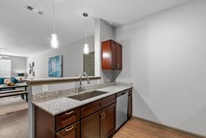 Shreveport apartment for rent - a kitchen with a granite counter top and a sink