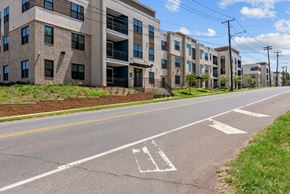 Shreveport apartment for rent - an empty street with an apartment building on the side of it