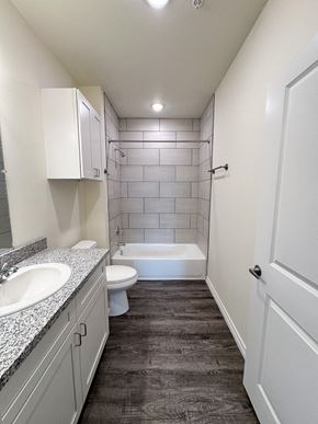 Beaumont apartment for rent - A bathroom with a white toilet, sink, and bathtub.