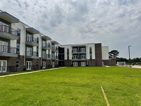 Beaumont apartment for rent - Apartment complex with a grassy area in front.