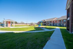 China apartment for rent - a playground with a slide in the middle of a grassy area