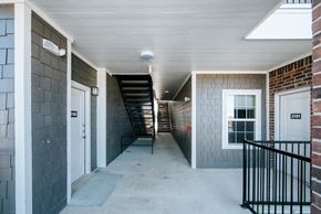 China apartment for rent - a hallway with two doors and a staircase in the background
