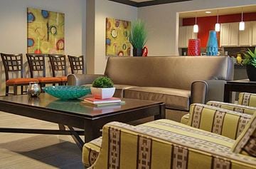 Fort Worth apartment for rent - A living room with a brown couch and a glass table.