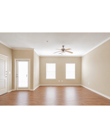 Orange apartment for rent - A room with a ceiling fan and three windows.