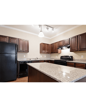 Orange apartment for rent - A kitchen with dark brown cabinets and a granite countertop.
