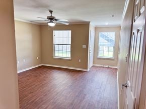 Freeport apartment for rent - A room with a ceiling fan and wooden flooring.