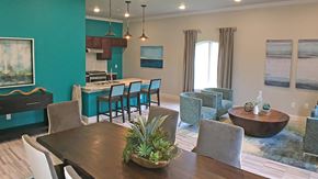 Orange apartment for rent - A dining room with a wooden table and chairs.