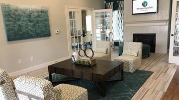 Orange apartment for rent - A living room with a fireplace and a painting on the wall.