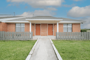Port Arthur apartment for rent - a house with red doors and a white picket fence