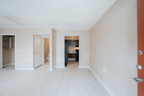 Port Arthur apartment for rent - a living room with a tiled floor and a kitchen in the background