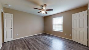 Bay City apartment for rent - an empty living room with a ceiling fan and a window